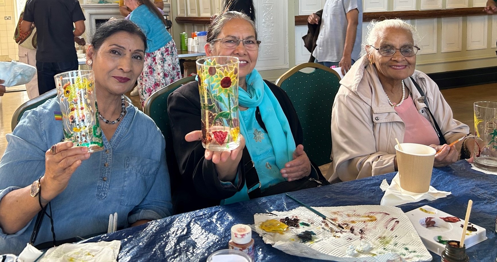 Ageing well fest picture of residents holding decorated glasses